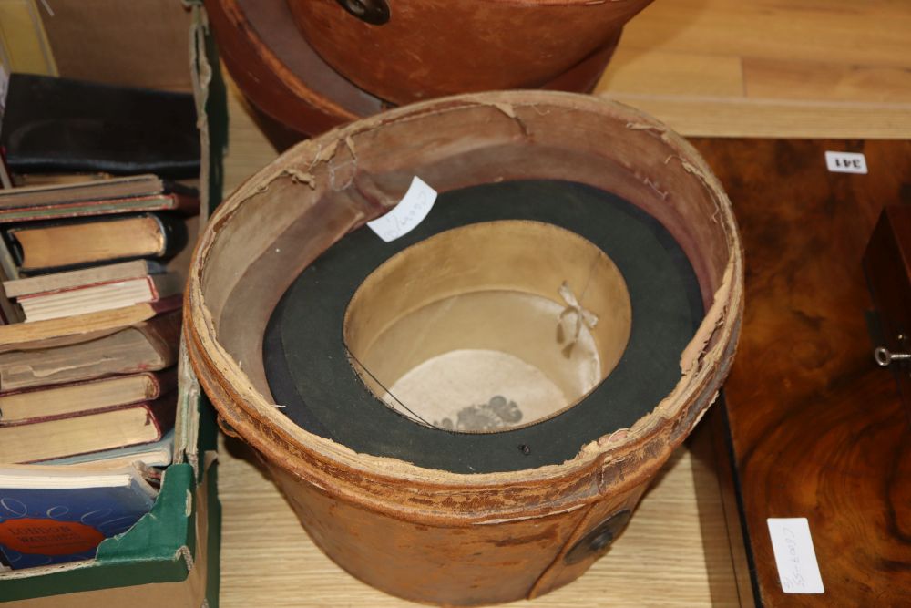 Three silk top hats and leather hat boxes